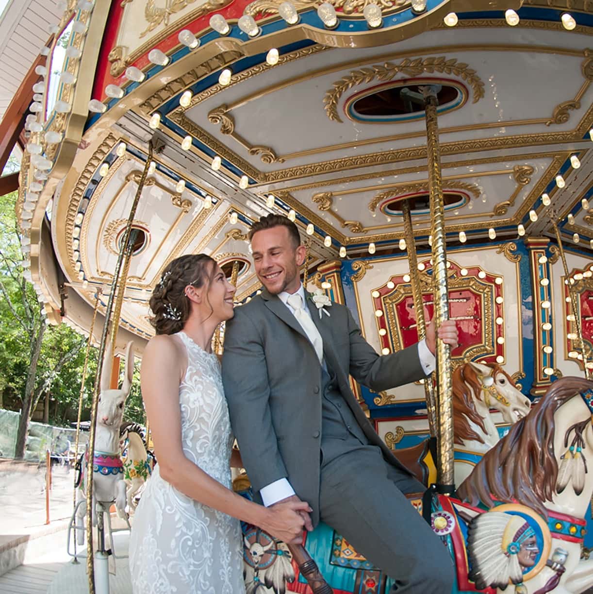 Newly married couple on carousel at Elmwood Park Zoo 