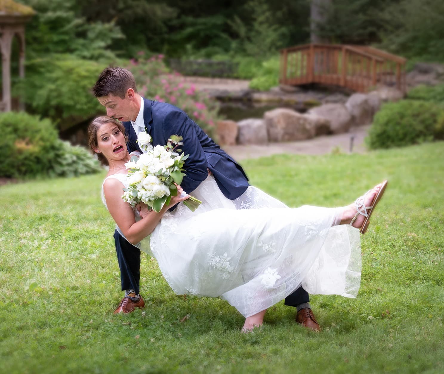Young couple at wedding pretending to fall