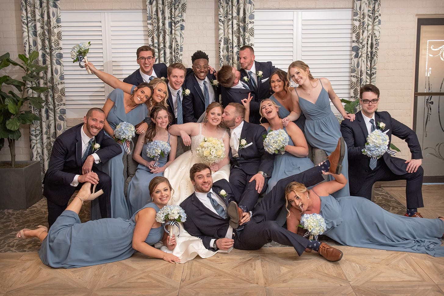 Young couple at wedding pretending to fall